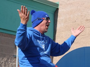 Joe Cebulski celebrates a miss while sitting in the hot seat of a dunk tank filled with water and pumpkin goop Saturday at the Fiery Faces Family Day held at the YMCA Petrolia.