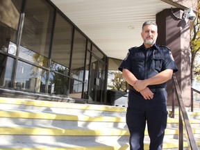 const.  Giovanni Sottosanti with Sarnia Police stands at the service's entrance to its Christina Street headquarters Tuesday.  Public access to the building's lobby was partially restored this week, to between 8 am and 8 pm weekdays.  (Tyler Kula/ The Observer)