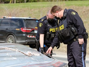 Police inspect a damaged boat after a collision on Oil Heritage Road near Discovery Line on Friday, April 23, 2021, in Petrolia.  (Terry Bridge/Sarnia Observer)