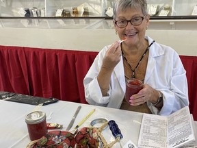 Judy Hughes of Rockton had a sweet job of judging the jam and jelly competition Monday at this year's Norfolk County Fair. SIMCOE REFORMER PHOTO