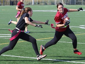 Kaydan Francoeur, right, of St. Charles Cardinals, evades Hailey Larochelle, of the Lively Hawks, during flag football action at James Jerome Sports Complex in Sudbury, Ont. on Monday October 3, 2022. John Lappa/Sudbury Star/Postmedia Network