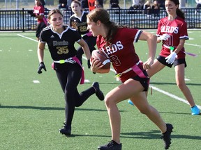 Bryn Hobson, right, of St. Charles Cardinals, attempts to evade Alexa Von Scheunemann, of the Lively Hawks, during flag football action at James Jerome Sports Complex in Sudbury, Ont. on Monday October 3, 2022. John Lappa/Sudbury Star/Postmedia Network