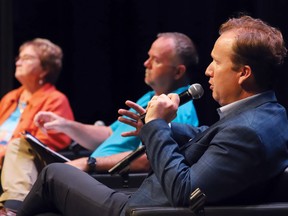 Mayoral candidate Paul Lefebvre, right, makes a point at the Greater Sudbury Chamber of Commerce mayoral candidates' fireside chat, which took place at College Boreal on Thursday evening.