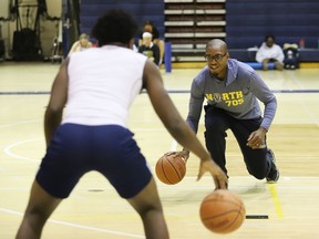 Laurentian Voyageurs men's basketball interim coach Georges Serresse leads players through a series of drills at the university in Sudbury, Ont. on Wednesday October 19, 2022. John Lappa/Sudbury Star/Postmedia Network