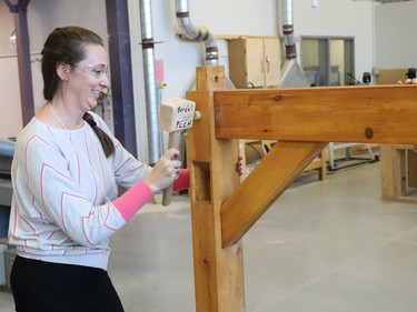 Melanie Savoie, of Ecole secondaire catholique l'Horizon, assembles a timber structure at College Boreal in Sudbury, Ont. on Thursday October 27, 2022. About 30 Grade 7 and 8 cooperative education teachers and guidance counsellors from various Conseil scolaire catholique Nouvelon schools participated in a training session on skilled trades at College Boreal. A release issued by the school board said, "During this session, offered jointly by College Boreal and CSC Nouvelon, participants will be informed about future employment opportunities, transferable skills, multiple post-secondary pathways and specialized high school programs (SHSM, COOP/OYAP, DCP and EL)." John Lappa/Sudbury Star/Postmedia Network