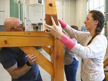 Al Therrien, a professor and coordinator of the carpentry program at College Boreal, looks on as Melanie Savoie, of Ecole secondaire catholique l'Horizon, assembles a timber structure at the college in Sudbury, Ont. on Thursday October 27, 2022. About 30 Grade 7 and 8 cooperative education teachers and guidance counsellors from various Conseil scolaire catholique Nouvelon schools participated in a training session on skilled trades at College Boreal. A release issued by the school board said, "During this session, offered jointly by College Boreal and CSC Nouvelon, participants will be informed about future employment opportunities, transferable skills, multiple post-secondary pathways and specialized high school programs (SHSM, COOP/OYAP, DCP and EL)." John Lappa/Sudbury Star/Postmedia Network