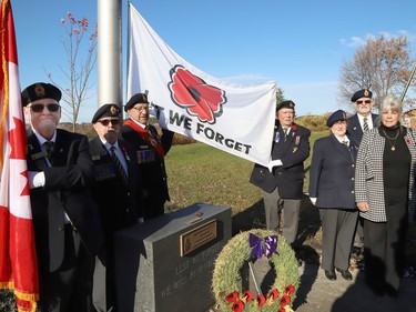 Greater Sudbury Deputy Mayor Joscelyne Landry-Altmann, right, and executive members of Branch 76 of the Royal Canadian Legion take part in a flag-raising ceremony recognizing October 28 to November 11 as Poppy Days at Branch 76 in Sudbury, Ont. on Friday October 28, 2022. John Lappa/Sudbury Star/Postmedia Network