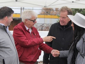 Barry Petroski, second from left, chats with Timmins MPP George Pirie and Mayor Kristin Murray while Porcupine District Agricultural Society president Rock Whissell, left, looks on during the last Mountjoy Farmers' Market event of the season held Saturday. Petroski and his wife Celina were honoured Saturday for donating the land which has provided the market with a permanent home.

RON GRECH/The Daily Press