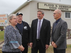 Standing in front of the Floyd Hembruff Civic Centre in Black River-Matheson, Dave Smith, parliamentary assistant for Ontario Northern Development Minister Greg Rickford, second from right, chats with, Kim Overholt and Chris Riach, president and vice-president respectively of the Matheson Agricultural Society and Township Mayor Gilles Laderoute. Smith was in Matheson Wednesday to publicly announce $293,089 in NOHFC funding for two community enhancement projects in Black River-Matheson, including recently completed improvements to the civic centre.

RON GRECH/The Daily Press