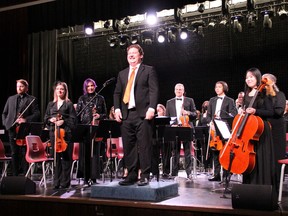 Conductor Josh Wood and the Timmins Symphony Orchestra enjoy a well-deserved standing ovation after their fun and scary Halloween Pops Spooktacular concert on Saturday at the Thériault auditorium. It was the first time the new principal cellist, Yu Pei, right, front, played with the symphony. Their next performance is Nov. 17, when the TSO Chamber Ensemble performs at St. Matthew's Anglican Cathedral.

NICOLE STOFFMAN/The Daily Press