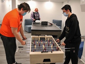 Isaiah Spicer, left, and Bradley Allen enjoy a game of foosball at the new home of the Youth Wellness Hub on Spruce Street South. The new permanent home for the Youth Wellness Hub opened this week.

ANDREW AUTIO/The Daily Press