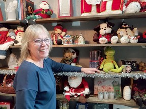 Food Bank manager Cathy Beaton displays some of the items that will be for sale during the annual Christmas sale. Behind her are many more decorations and Christmas themed items that will be available on Nov. 21.