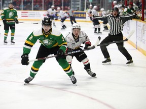 Sam Dickinson and Thomas Chafe race for the puck in the first period as the Owen Sound Attack host the London Knights inside the Harry Lumley Bayshore Community Centre on Wednesday, Oct. 19, 2022. Greg Cowan/The Sun Times