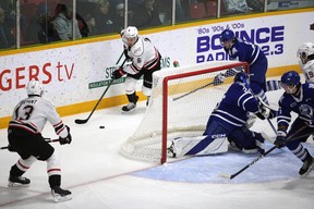 Nolan Seed tries to dish Gavin Bryant out the back door as Alessio Beglieri glances the wrong way in the first period as Owen Sound offense hosts Mississauga Steelheads inside from the Harry Lumley Bayshore Community Center on Saturday, October 8, 2022. Greg Cowan/The Hours of the Sun