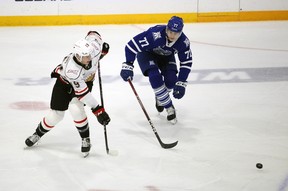 Julian Fantino prepares to make a pass in the middle of the ice with Ethan Del Mastro in pursuit as the Owen Sound offense hosts the Mississauga Steelheads inside the Harry Lumley Bayshore Community Center on Saturday October 8, 2022. Greg Cowan / The Sun Times