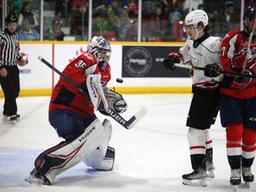 Mattias Onuska makes a save while Cedrick Guindon and Michael Renwick jostle in front of the net as the Owen Sound Attack host the Windsor Spitfires inside the Harry Lumley Bayshore Community Centre on Saturday, Oct. 15, 2022. Greg Cowan/The Sun Times