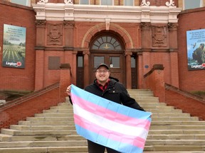 Stratford-Perth Pride is hosting Perth County's first Trans Pride Week Nov. 13-20 with a number of local events including a clothing swap and a candlelight vigil in Upper Queen's Park on Trans Day of Remembrance Nov. 20. Pictured, Stratford-Perth Pride president and board chair AJ Adams stands with a transgender Pride flag in front of Stratford city hall. (Galen Simmons/The Beacon Herald)