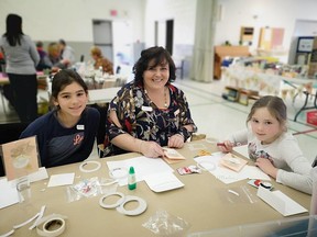Zonta Club of Chatham-Kent member Corrinne Kennedy, centre, participates in the club's Christmas Card Making Extravaganza from a previous year with her two nieces. (Handout/Postmedia Network)