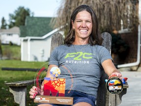 Angela Lilly sits alongside her Ironman 70.3 World Championship medal and award after placing second in her division during the competition held in Utah. ALEX FILIPE