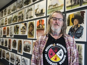 Artist Ken Leighton stands in front of a portion of paintings he created as part of his "Truth and Reconciliation Project" which is currently open for attendees at 50 Quinte Street in Trenton, Ontario. ALEX FILIPE