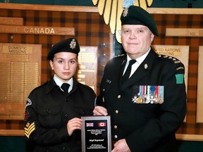 Mcpl. Bailey Raymond receives a recognition award from Honorary Colonel Kevin McCormick of the Irish Regiment of Canada.