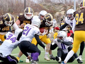 Gabe Byron (5) of the Korah Colts is tackled by Massi Grossi (21), Evan Russel (25), Matthew Korzeniecki (11), Taylor Daniels (34) and Jamie Burrell (51) of the Lo-Ellen Park Knights during NOSSA senior boys football semifinal action at James Jerome Sports Complex in Sudbury, Ontario on Saturday, November 5, 2022.