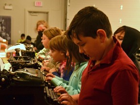 Brock Hellens, a grade 5 student from Milverton Public School, learns how to use a typewriter with his classmates at the Stratford-Perth Museum Tuesday. (Galen Simmons/The Beacon Herald)