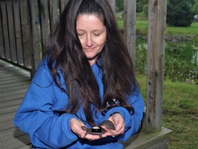Laura Brandt, Magnetawan's deputy clerk, displays one of nine geocaches hidden in the village. This particular cache is contained in a turtle-shaped figurine.