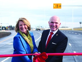 Leduc County Mayor Tanni Doblanko, Federal Minister of Tourism Randy Boissonnault, Beaumont Mayor Bill Daneluik, Edmonton Mayor Amarjeet Sohi, and other dignitaries and officials were on hand October 28 for the ribbon cutting of the next stage of Nisku Spine Road. Two new lanes now connect Township Road 510 to Airport Road. (Dillon Giancola)