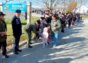 Several young people took part in a tradition to shake hands with veterans following a Remembrance Day ceremony held on Walpole Island First Nation Thursday.  (Ellwood Shreve/Chatham Daily News)