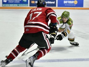 Paul Christopoulos of the host North Bay Battalion defends against Danny Zhilkin of the Guelph Storm in their Ontario Hockey League game Thursday night. The Troops visit the Barrie Colts at 7:30 p.m. Saturday.