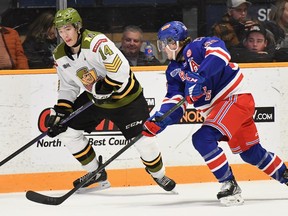Dalyn Wakely of the North Bay Battalion looks to make a play under the watch of the visiting Kitchener Rangers' Reid Valade in their Ontario Hockey League game Sunday. The Troops entertain the Kingston Frontenacs at 7 p.m. Thursday.