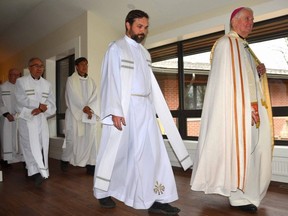 Bishop Douglas Crosby, Oblate of Mary Immaculate, ninth bishop of the Diocese of Hamilton, right, walks through the newly constructed St. Mary's Rectory after blessing it along with Father Wojtek Kuzma, St. Mary's Catholic Church priest, in Owen Sound on Saturday, November 12, 2022.