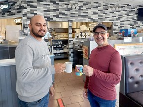 Koullies Stylianou (right), who has been making pizzas in Chatham for over 42 years and retired on Nov. 7,  has sold his estaurant Andy's Place to Harshana Fernando. Ellwood Shreve/Postmedia