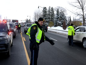 Perth County OPP and the Stratford Police Service launched their joint Festive RIDE (Reduce Impaired Driving Everywhere) program in Stratford Wednesday afternoon. Pictured, officers from both police services conducted roadside impairment checks of drivers on Ontario Street in Stratford's east end. Galen Simmons/The Beacon Herald/Postmedia Network