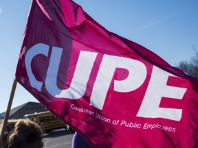 Ontario's education workers, and their supporters, picket outside of Bay of Quinte MPP Todd Smith's office as workers walked off the job on Friday in Belleville, Ontario. ALEX FILIPE