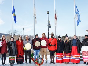 Red skirts on the right are designed by Mueller. (Left to right) Allisa Dullemond, Cassandra Veerling, Priscilla Lalonde, Carol Ridsdale, Georgie Isadore, Miksiw Bellerose, Mihkwa Bellerose, Cst. Arthur Sunday, Cpl. Courtney Tipton, Cpl. Michelle Phillips, Cst. Julie-Ann Strilaiff, Wendy Goulet, and Barry Dibb.