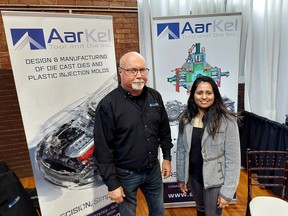Dennis Alexander, left, operations manager at AarKel Tool and Die Inc. and Julie John, human resources manager, collective several resumes at the Chatham-Kent Community Job Fair held at The Chatham Armoury on Nov. 15. Ellwood Shreve/Postmedia