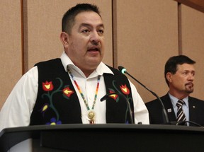 Aamjiwnaang First Nation Chief Chris Plain leads the inaugural meeting of the 2022-2026 Sarnia City Council on November 15.  Lambton County Warden Kevin Marriott looks on.  Tyler Kula/Postmedia