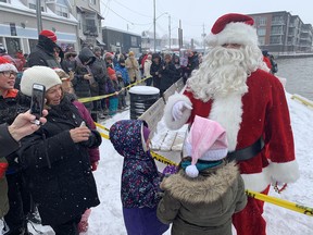 Santa Claus spent a few minutes speaking with children before he and Mrs. Claus got on a horse-drawn sleigh to participate in Port Dover's Christmas Fest and Santa Claus Parade on Nov. 19. Vincent Ball