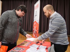 Wesley Kovacs from Nixon, on the left, talks with Spencer Holmes from Port Dover's Lower Lakes Towing Ltd. at the Grand Erie Aspire Job Fair on Nov. 16 in Delhi. CHRIS ABBOTT