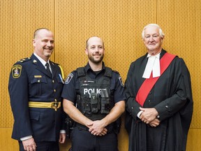 From left, Belleville Police service Dep. Chief Chris Barry, Cst. Aaron Wentzell and Justice Stephen Hunter pose inside of a courtroom at the Quinte Consolidated Courthouse on Tuesday in Belleville, Ontario. ALEX FILIPE