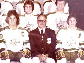 Bud Burke sits among Sudbury Wolves players while posing for a team photo in the 1970s.