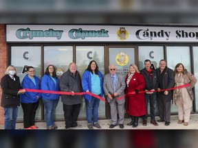 Quinte West municipal and business leaders stand alongside owners of the Crunchy Canuck as they cut the ceremonial red ribbon, opening the new business. Submitted.