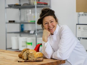 Whole Note Grains Co. owner and head baker Michelle MacKinnon poses alongside some freshly baked bread inside her newly opened kitchen in Trenton, Ontario. Submitted.