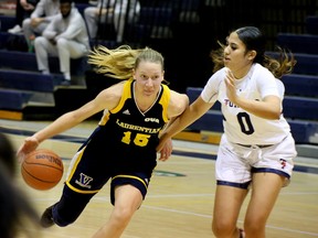 Bailey Tabin (15) of the Laurentian Voyageurs drives toward the basket while Jada Poon Tip (0) of the University of Toronto Varsity Blues defends during OUA women's basketball action in the Ben Avery gym in Sudbury, Ontartio on Saturday, November 26 , 2022.