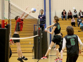 Jacob Leduc (10) of the Ecole secondaire catholique l’Horizon Aigles attempts a spike against St. Thomas Aquinas during the OFSAA boys A volleyball bronze-medal match at Cambrian College in Sudbury, Ontario on Saturday, November 26, 2022. Ben Leeson/The Sudbury Star/Postmedia Network