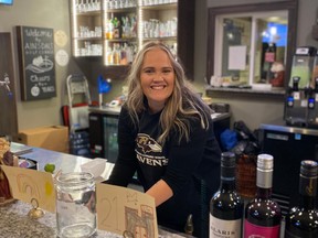 Taylor Candler, co-owner of Ainsdale Golf Course, stands behind the bar during a fundraiser the golf couse hosted in support of the Ripley-Huron Community School playground project. Submitted photo.