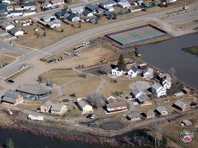 Fort McMurray Heritage Village is surrounded by floodwaters on the morning of April 27, 2020. Construction of the flood berm can be seen in the top right. Photo by McMurray Aviation