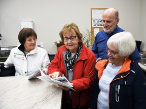 Margaret Thompson, Linda Henderson, board member Robert Clark and Jane Jarvis look over a pamphlet in the kitchen area of the Ridgetown and Area Adult Activity Centre during an open house on Nov. 28. Tom Morrison/Chatham This Week